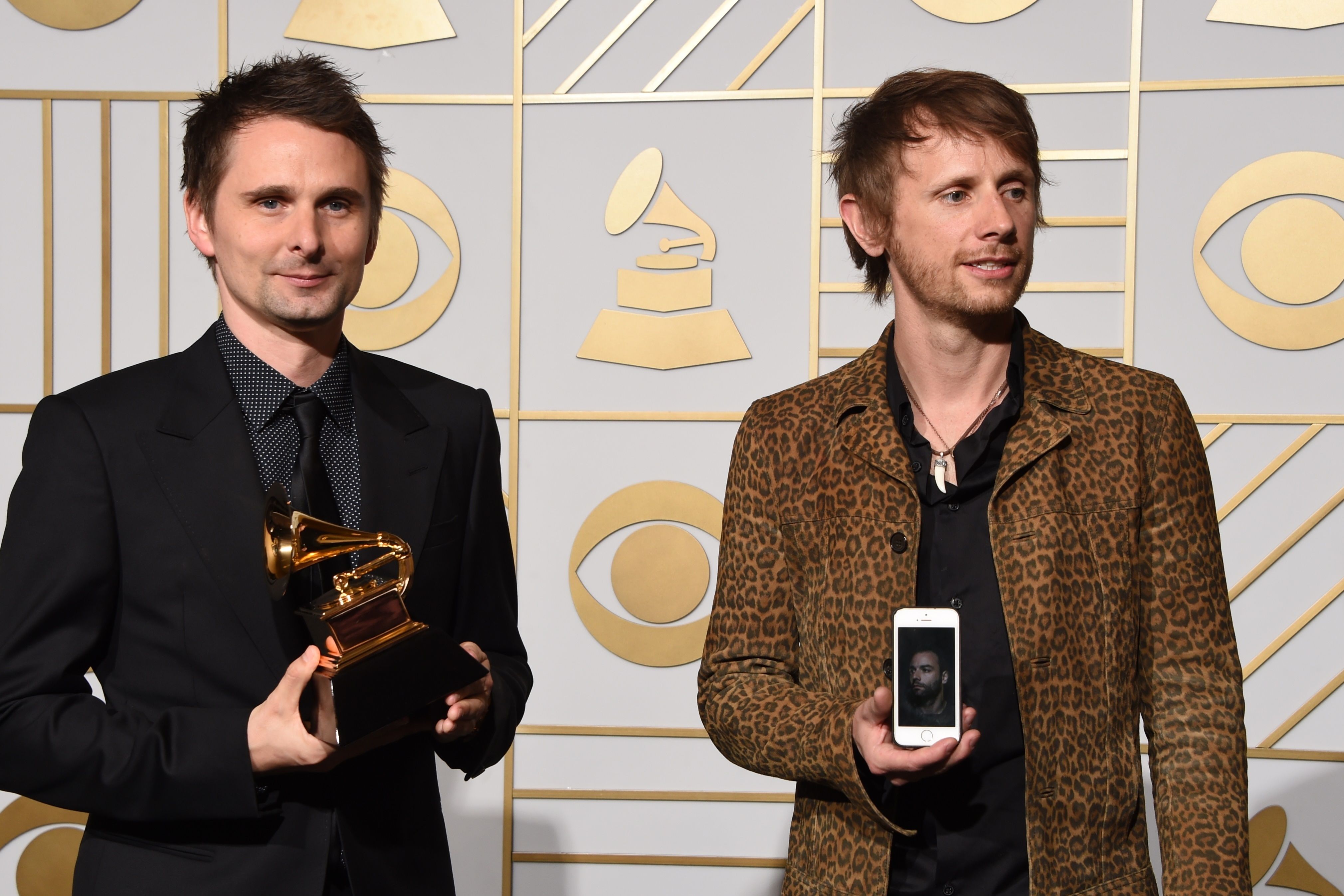 Muse pose in the press room with their Best Rock Album trophy for "Drone" during the 58th Annual Grammy Music Awards in Los Angeles on February 15, 2016. AFP PHOTO / Mark RALSTON / AFP / MARK RALSTON