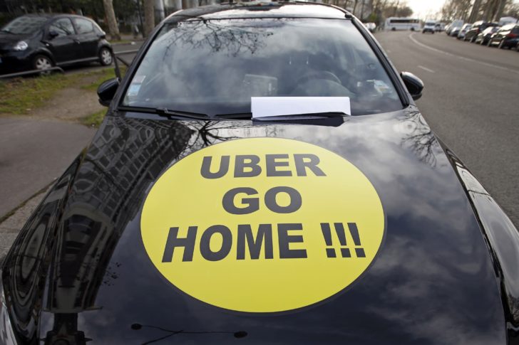 A striking French taxi drivers displays the message,