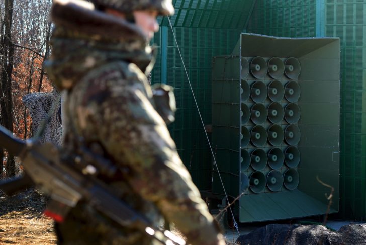 A South Korean soldier stands next to loudspeakers just south of the demilitarized zone separating the two Koreas in Yeoncheon