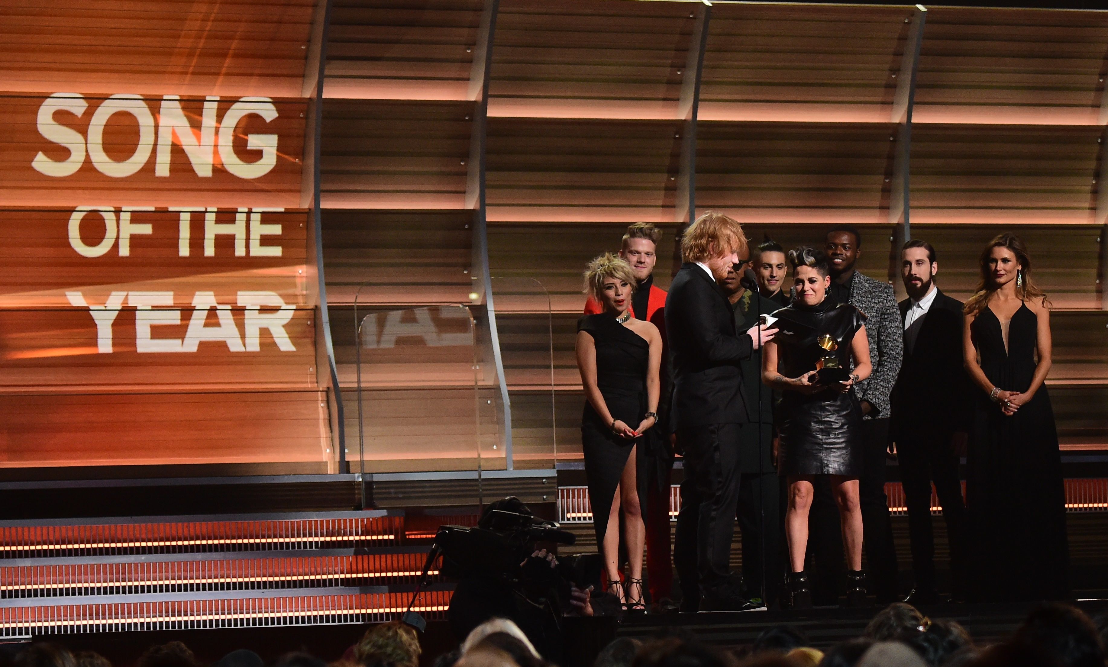 Ed Sheeran (3L) recieves the award for the Song of the Year, Thinking Out Loud during the 58th Annual Grammy music Awards in Los Angeles February 15, 2016. AFP PHOTO/ ROBYN BECK / AFP / ROBYN BECK