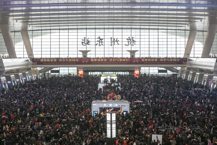 Passengers crowd at the waiting hall inside a railway station after trains were delayed due to heavy snow, during the travel rush ahead of the upcoming Spring Festival, in Hangzhou, Zhejiang province