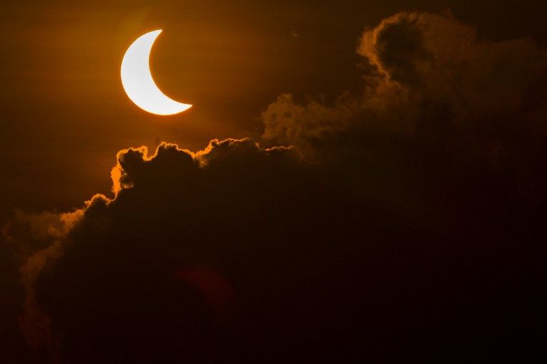 A solar eclipse is pictured from Banda Aceh on March 9, 2016. A total solar eclipse swept across the vast Indonesian archipelago on March 9, witnessed by tens of thousands of sky gazers and marked by parties, Muslim prayers and tribal rituals. / AFP / CHAIDEER MAHYUDDIN