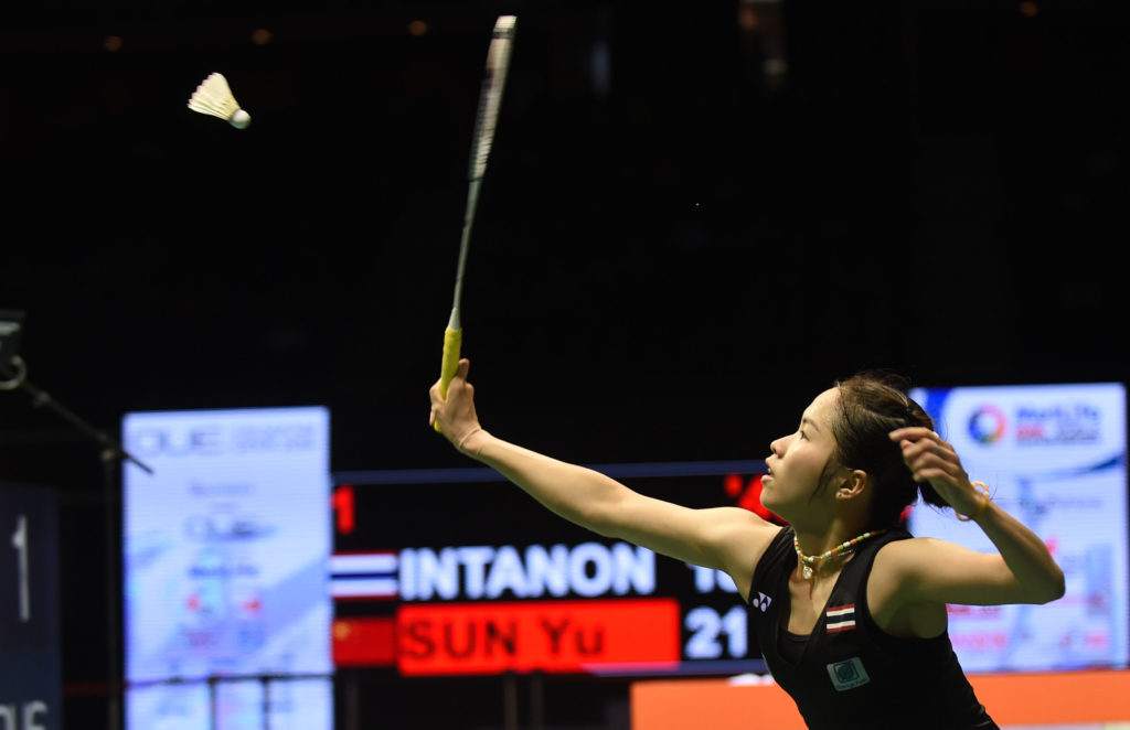 Ratchanok Intanon of Thailand returns a shot against Sun Yu of China during the women's singles final at the Singapore Open badminton tournament in Singapore on April 17, 2016. / AFP PHOTO / MOHD FYROL