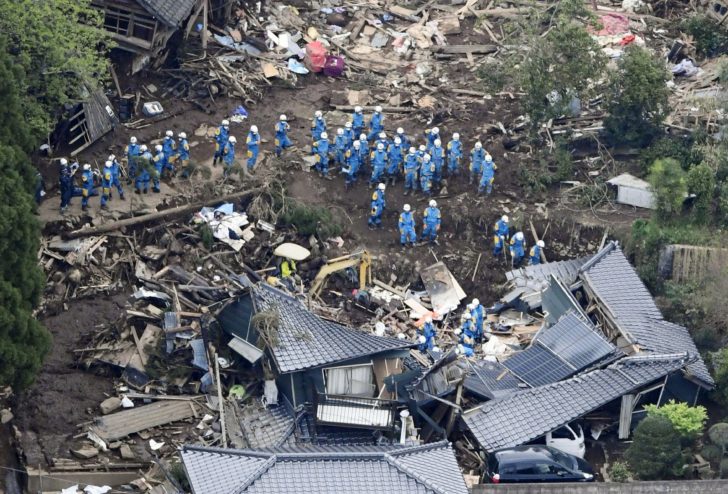 Rescue workers conduct a search and rescue operation to a collapsed house at a landslide site caused by earthquakes in Minamiaso town, Japan