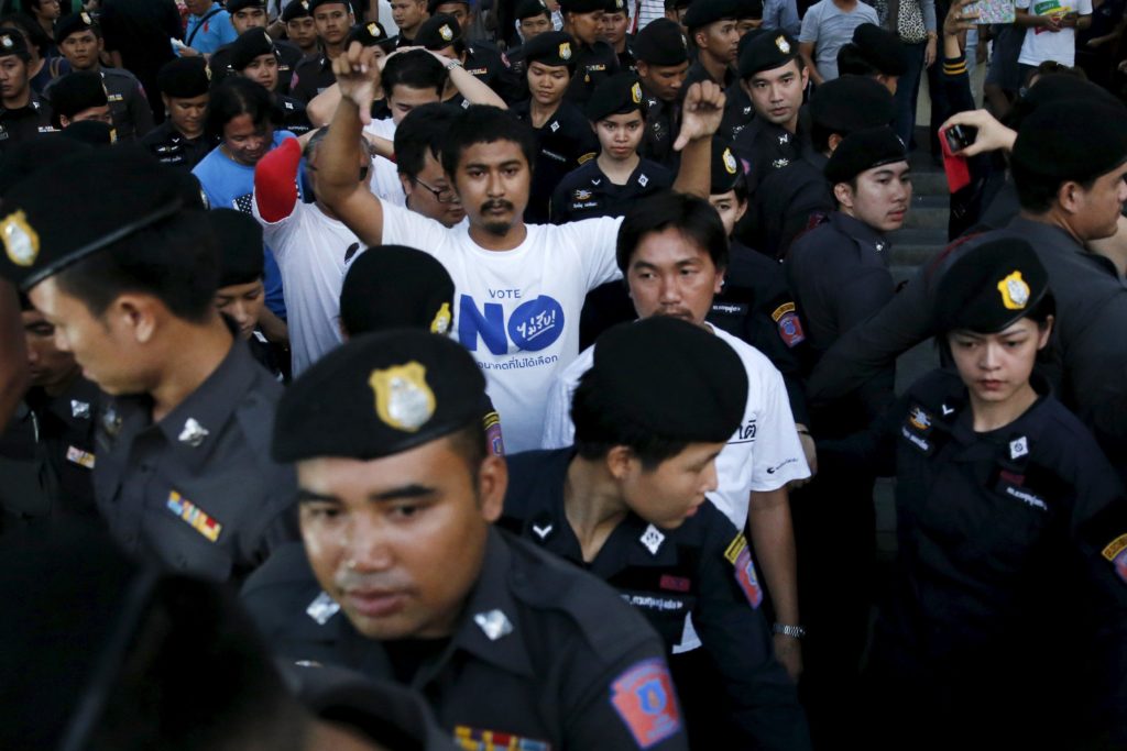 Student activists are detained during a silent protest after Thailand's election commission filed charges against a group for posting "foul and strong" comments online criticising a military-backed draft constitution