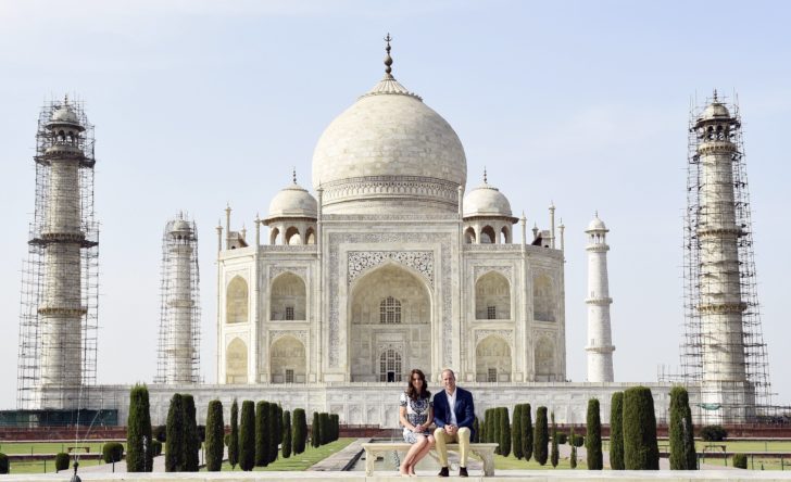 Britain's Prince William and his wife Catherine, the Duchess of Cambridge, pose as they sit in front of the Taj Mahal in Agra