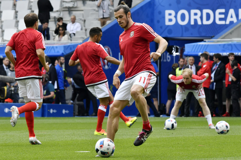 Wales' forward Gareth Bale warms up prior to the start of the Euro 2016 group B football match between Wales and Slovakia at the Stade de Bordeaux in Bordeaux on June 11, 2016. / AFP PHOTO / GEORGES GOBET