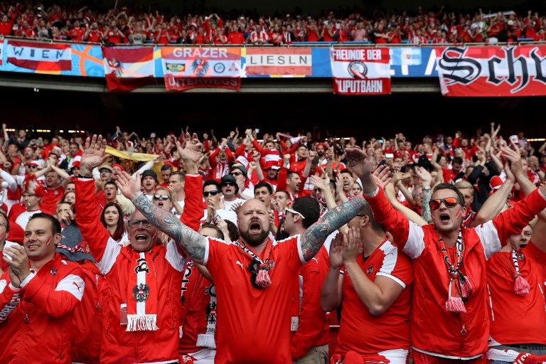 Austria fans cheer their team before the start of the the Euro 2016 group F football match between Portugal and Austria at the Parc des Princes in Paris on June 18, 2016. / AFP PHOTO / KENZO TRIBOUILLARD