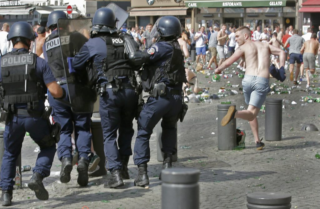 Football Soccer - Euro 2016 - England v Russia - Group B - Stade Velodrome, Marseille, France - 11/6/16 Police chase a supporter at the port of Marseille. REUTERS/Jean-Paul Pelissier