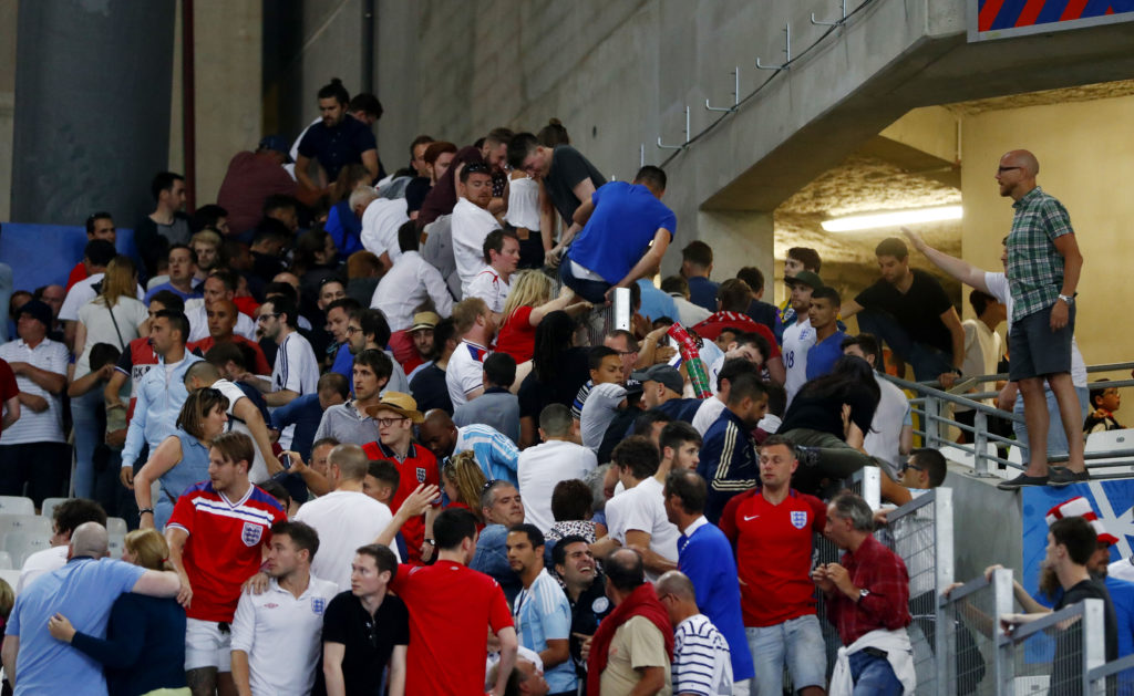 Football Soccer - England v Russia - EURO 2016 - Group B - Stade Vélodrome, Marseille, France - 11/6/16 England fans climb over a fence to escape trouble in the stadium after the game REUTERS/Kai Pfaffenbach Livepic