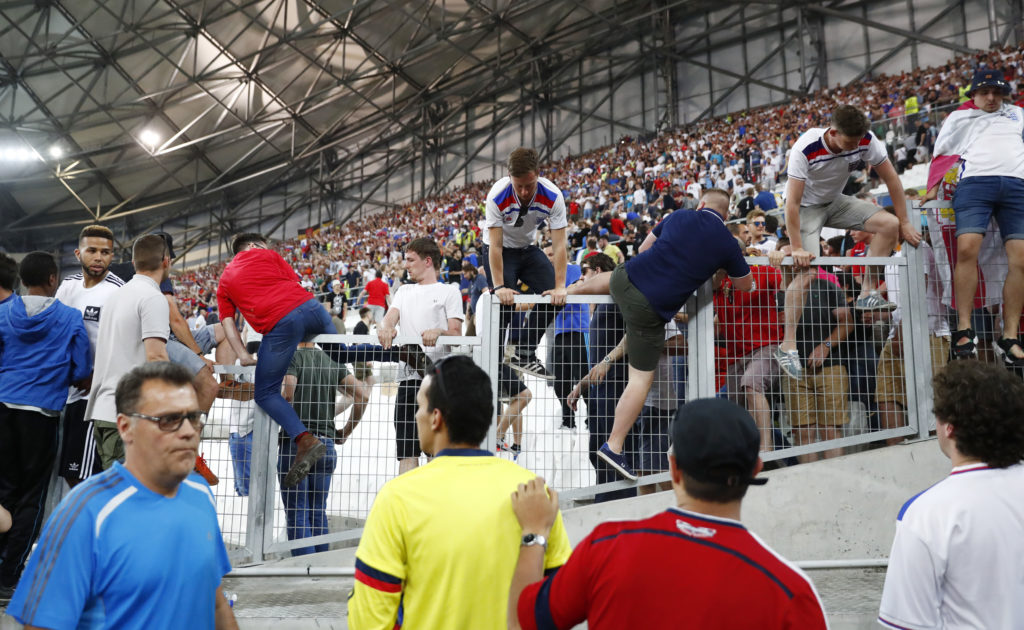 Football Soccer - England v Russia - EURO 2016 - Group B - Stade Vélodrome, Marseille, France - 11/6/16 England fans climb over a fence to escape trouble in the stadium after the game REUTERS/Kai Pfaffenbach Livepic