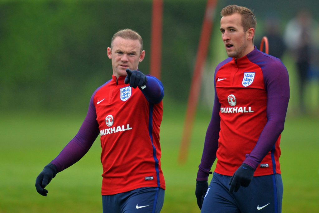 England's striker Wayne Rooney (L) gestures as talks with England's striker Harry Kane during a team training session in Watford, north of London, on June 1, 2016. England are set to play Portugal in an international friendly football match at Wembley on June 2, ahead of Euro 2016. / AFP PHOTO / GLYN KIRK / NOT FOR MARKETING OR ADVERTISING USE / RESTRICTED TO EDITORIAL USE