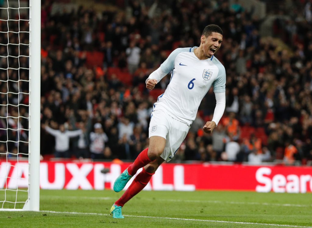 England's defender Chris Smalling celebrates after scoring during the friendly football match between England and Portugal at Wembley stadium in London on June 2, 2016. / AFP PHOTO / ADRIAN DENNIS