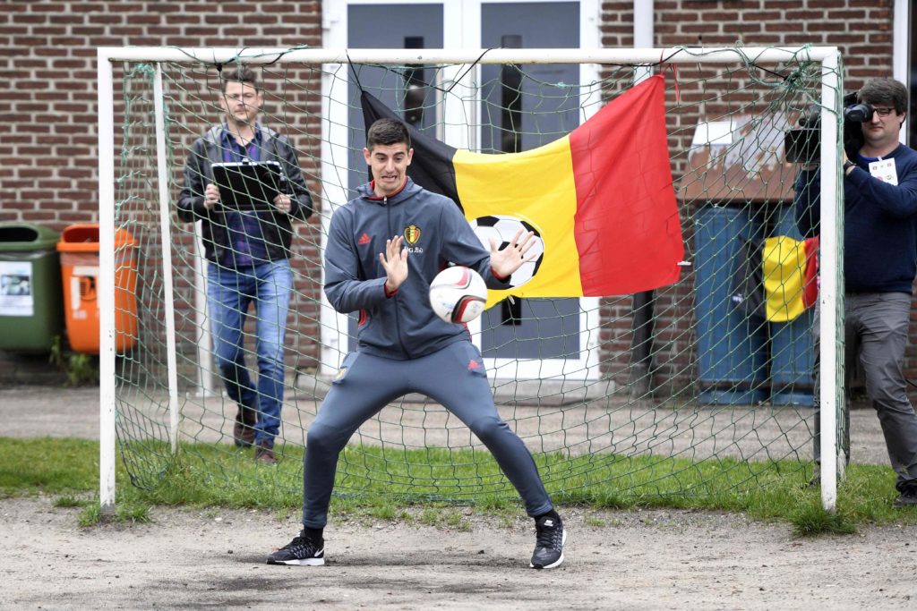 Belgium's goalkeeper Thibaut Courtois (C) stops a ball during a visit to the primary school 'De Viejool' in Hechtel-Eksel on June 3, 2016, few days before the start of the Euro 2016 Championship in France. / AFP PHOTO / BELGA / YORICK JANSENS / Belgium OUT