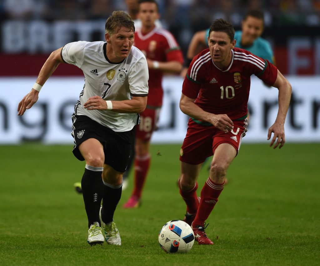 Germany's midfielder Bastian Schweinsteiger (L) and Hungary´s Zoltan Gera vie during the UEFA EURO 2016 friendly football match Germany vs Hungary at the Veltins Arena in Gelsenkirchen, western Germany on June 4, 2016. / AFP PHOTO / PATRIK STOLLARZ