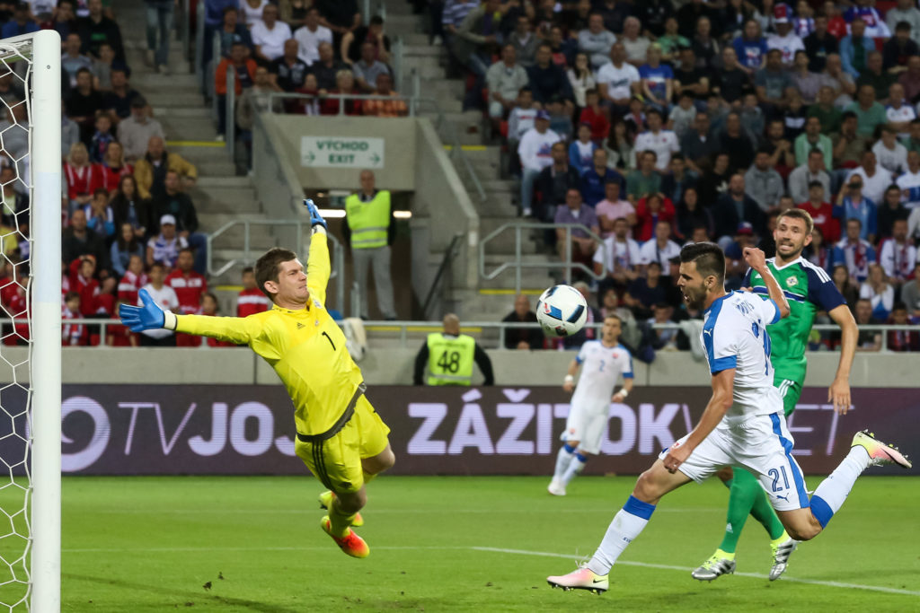 Norhern Ireland's goalkeeper Michael McGovern (L) and Slovakia's Michal Duris and Northern Ireland's Gareth McAuley vie for a ball during the a UEFA EURO 2016 friendly football match between Slovakia and Northern Ireland in Trnava, on June 4, 2016. / AFP PHOTO / VLADIMIR SIMICEK