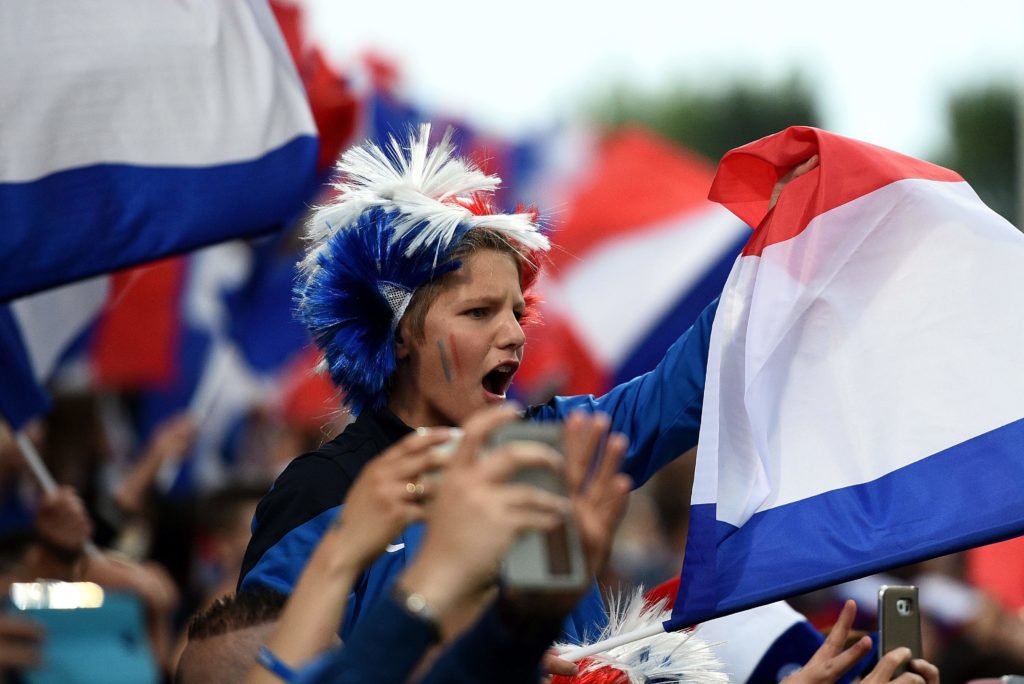 A young France's supporter cheers for his team prior to the friendly football match between France and Scotland, at the St Symphorien Stadium in Longeville-lès-Metz, Eastern France, on June 4, 2016.  / AFP PHOTO / FRANCK FIFE