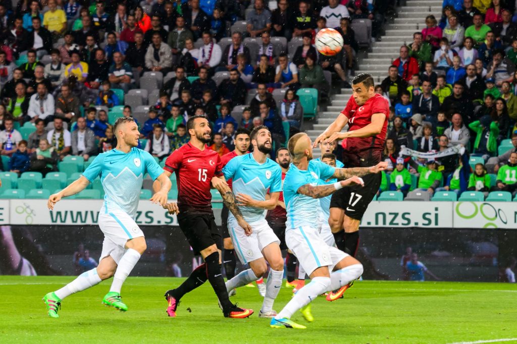 Turkey's Burak Yilmaz (R) heads the ball during the friendly football match Turkey versus Slovenia at the Stadium Stozice in Ljubljana, on June 5, 2016. / AFP PHOTO / Jure Makovec/AFP