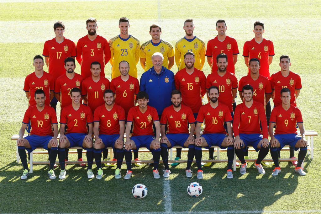 A handout picture provided on June 5, 2016 by RFEF shows the players of the national spanish football team posing at the Ciudad de Futbol in Las Rozas, near Madrid. (From left) Top row: midfielder Mikel San Jose, defender Gerard Pique, goalkeeper Sergio Rico, goalkeeper Iker Casillas, goalkeeper David de Gea, midfielder Sergio Busquets, defender Marc Bartra. Middle row: forward Aritz Aduriz, forward Nolito, forward Pedro, midfielder Andres Iniesta, coach Vicente del Bosque, defender Sergio Ramos, midfielder Cesc Fabregas, midfielder Thiago, defender Hector Bellerin. Bottom row: midfielder Bruno, defender Cesar Azpilicueta, midfielder Koke, forward Silva, defender Jordi Alba, defender Juanfran, froward Alvaro Morata, midfielder Lucas Vazquez. / AFP PHOTO / RFEF / CARMELO RUBIO / RESTRICTED TO EDITORIAL USE - MANDATORY CREDIT "AFP PHOTO / BMI" - NO MARKETING NO ADVERTISING CAMPAIGNS - DISTRIBUTED AS A SERVICE TO CLIENTS == NO ARCHIVE