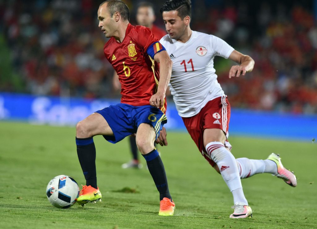 Georgia's forward Giorgi Chanturia (R) vies for the ball with Spain's midfielder Andres Iniesta during the EURO 2016 friendly football match Spain vs Georgia at the Coliseum Alfonso Perez stadium in Getafe, on June 7, 2016, in preparation for the upcoming Euro 2016 European football championship. / AFP PHOTO / GERARD JULIEN