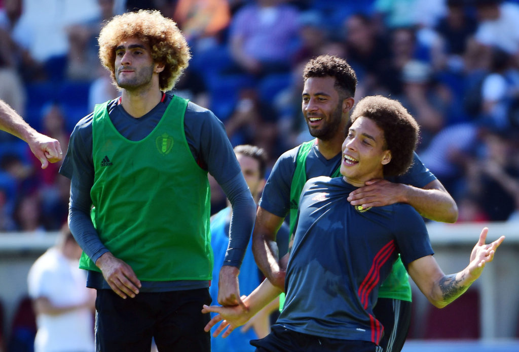 Belgium's midfielder Marouane Fellaini (L), Belgium's midfielder Moussa Dembele (C) and Belgium's midfielder Axel Witsel joke as they take part in a public training session during the Euro 2016 football tournament at the Chaban-Delmas Stadium in Bordeaux, on June 8, 2016.   / AFP PHOTO / EMMANUEL DUNAND