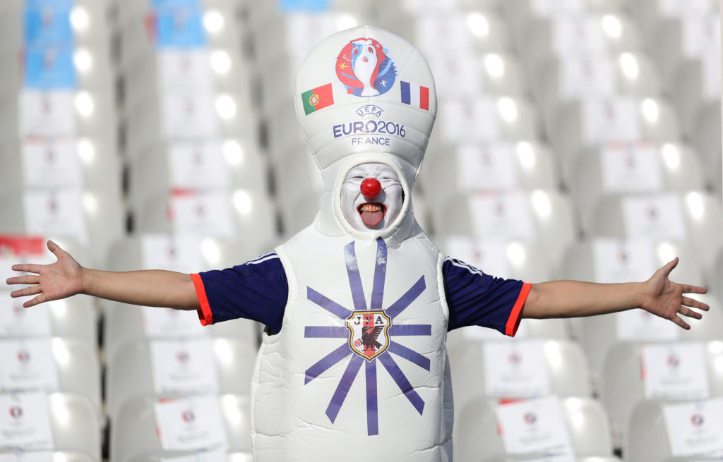 A supporter poses prior to the Euro 2016 final football match at the Stade de France in Saint-Denis, north of Paris, on July 10, 2016. / AFP PHOTO / Valery HACHE