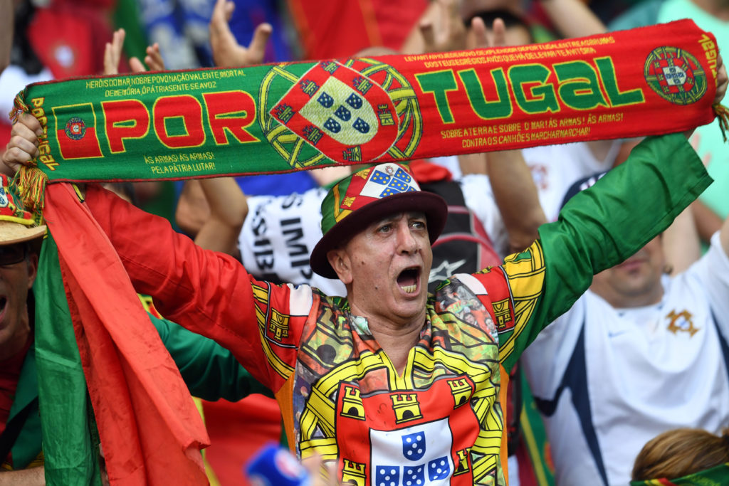 A Portugal supporter cheers ahead of the Euro 2016 final football match between Portugal and France at the Stade de France in Saint-Denis, north of Paris, on July 10, 2016. / AFP PHOTO / FRANCISCO LEONG