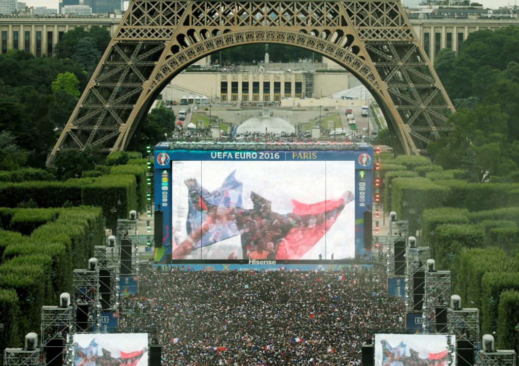 An aerial picture shows France supporters cheering during the Euro 2016 final football match between Portugal and France at the Champ de Mars fan zone in Paris on July 10, 2016. With each France match, the 90,000 capacity fan zone at the foot of the Eiffel Tower has been progressively fuller. / AFP PHOTO / GEOFFROY VAN DER HASSELT