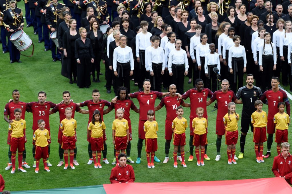 Portugal's players sing the national anthem during the closing ceremony ahead the Euro 2016 final football match between Portugal and France at the Stade de France in Saint-Denis, north of Paris, on July 10, 2016. / AFP PHOTO / MIGUEL MEDINA