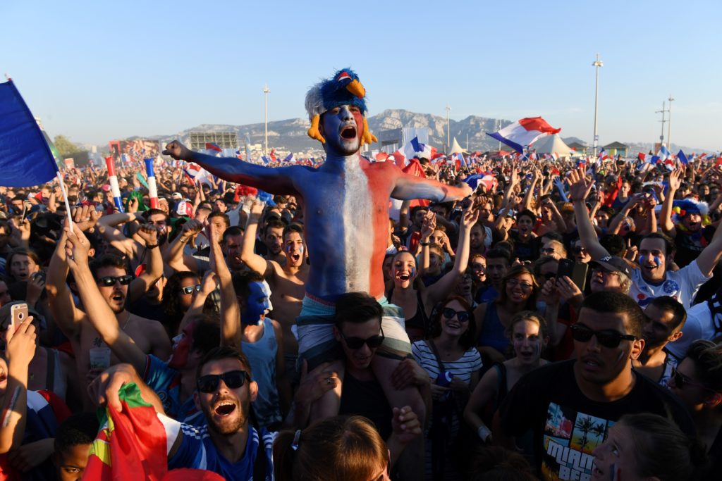 France supporters cheer prior to the Euro 2016 final football match between Portugal and France at the Marseille Fan Zone, on July 10, 2016. / AFP PHOTO / BORIS HORVAT