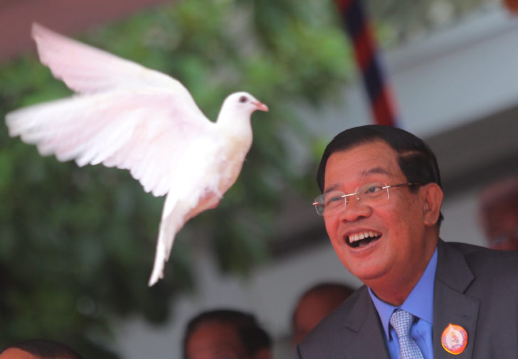 President of the ruling Cambodian People's Party (CPP) and Prime Minister Hun Sen releases a dove during a ceremony at the party headquarters to mark the 65th anniversary of the establishment of the party in Phnom Penh