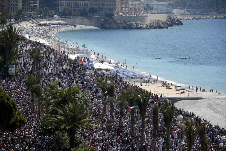 A general view shows the crowd gathering on the Promenade des Anglais during a minute of silence on the third day of national mourning to pay tribute to victims of the truck attack in Nice