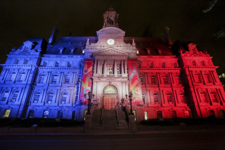 Montreal City Hall is illuminated with the colors of France in Montreal