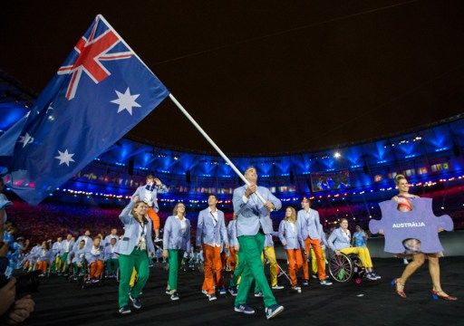 Bradley Ness, representing Australia in Wheelchair Basketball, leads his fellow athletes into the arena during the Opening Ceremony of the Rio 2016 Paralympic Games at the Maracana Stadium in Rio de Janeiro, Brazil, on September 7, 2016. Photo by Al Tielemans/OIS/IOC via AFP. RESTRICTED TO EDITORIAL USE. / AFP PHOTO / OIS/IOC / Al Tielemans for OIS/IOC