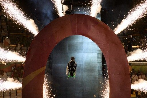 Aaron Wheelz, extreme wheelchair athlete, makes a spectacular entrance at the start of the opening ceremony of the Paralympic Games at Maracana Stadium in Rio de Janeiro, Brazil, on September 7, 2016. / AFP PHOTO / YASUYOSHI CHIBA