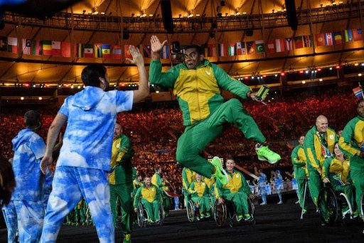 Members of South Africa's delegation enter during the opening ceremony of the Rio 2016 Paralympic Games at the Maracana stadium in Rio de Janeiro on September 7, 2016. / AFP PHOTO / YASUYOSHI CHIBA