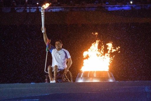 Brazilian swimmer Clodoaldo Silva holds the Paralympic torch after lighting the Paralympic cauldron during the opening ceremony of the Rio 2016 Paralympic Games at the Maracana stadium in Rio de Janeiro on September 7, 2016. / AFP PHOTO / YASUYOSHI CHIBA