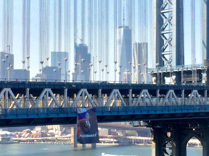 A banner with an image of Russian President Vladimir Putin hangs from the Manhattan Bridge in New York City