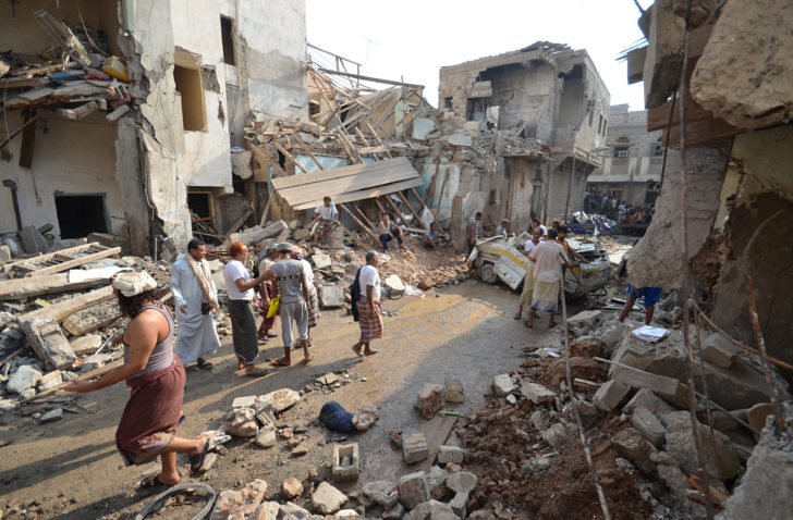 People gather at the site of a Saudi-led air strike in the Red Sea port city of Hodeidah