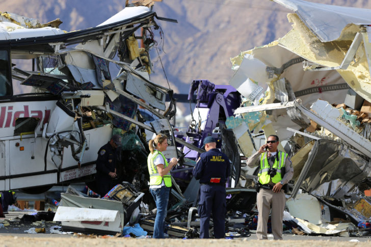 Investigators speak to each other at the scene of a mass casualty bus crash on the westbound Interstate 10 freeway near Palm Springs