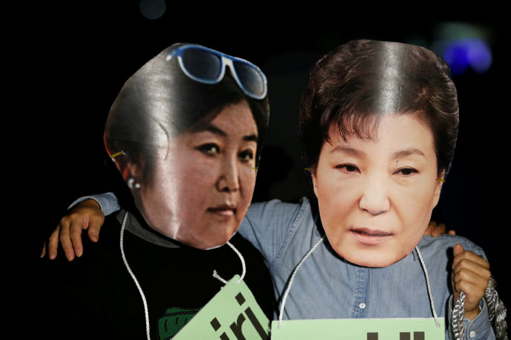 Protesters wearing cut-out of South Korean President Park Geun-hye and Choi Soon-sil attend a protest denouncing President Park Geun-hye over a recent influence-peddling scandal in central Seoul