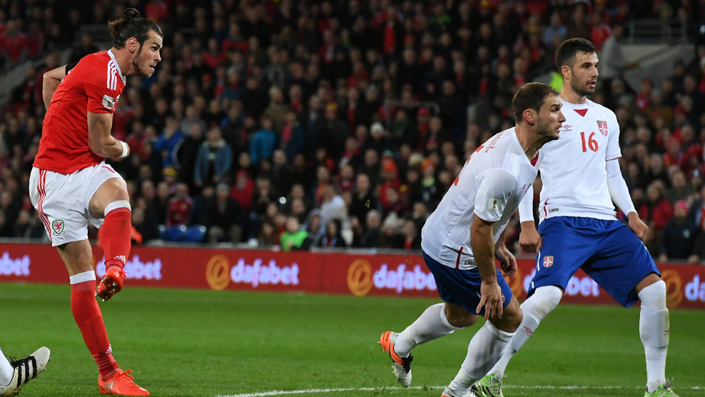 Wales' forward Gareth Bale (L) watches as his shot puts Wales ahead during the World Cup 2018 qualification match between Wales and Serbia at Cardiff City stadium in Cardiff on November 12, 2016. / AFP / Anthony DEVLIN (Photo credit should read ANTHONY DEVLIN/AFP/Getty Images)