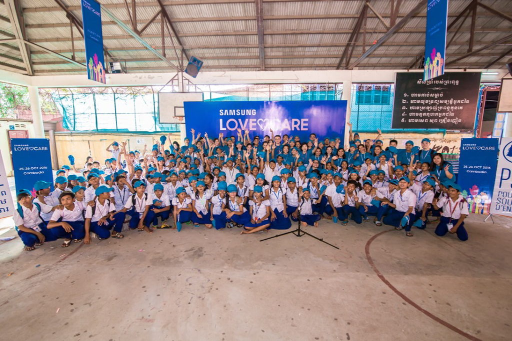 Volunteers and children sharing a photo moment at PSE_resized