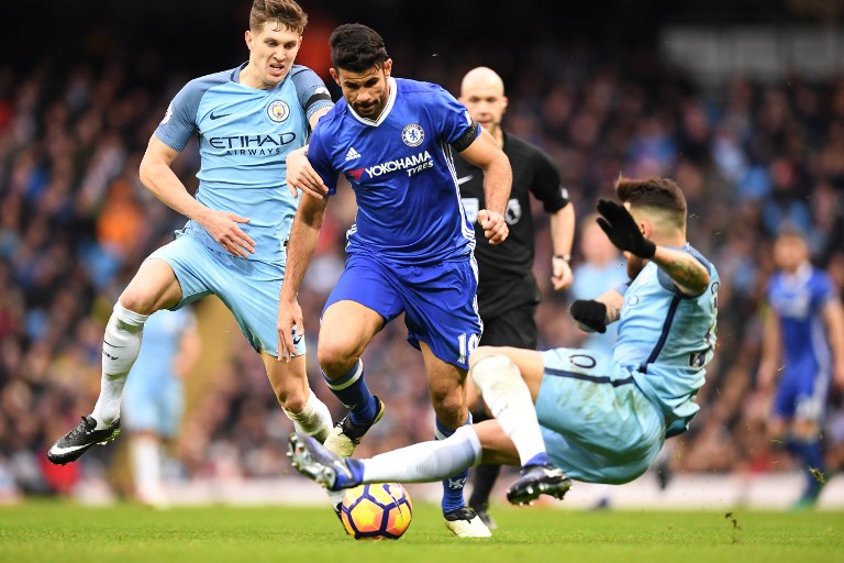 Chelsea's Brazilian-born Spanish striker Diego Costa (C)v ies with Manchester City's English defender John Stones (L) and Manchester City's Argentinian defender Nicolas Otamendi during the English Premier League football match between Manchester City and Chelsea at the Etihad Stadium in Manchester, north west England, on December 3, 2016. / AFP PHOTO / Paul ELLIS / RESTRICTED TO EDITORIAL USE. No use with unauthorized audio, video, data, fixture lists, club/league logos or 'live' services. Online in-match use limited to 75 images, no video emulation. No use in betting, games or single club/league/player publications. /