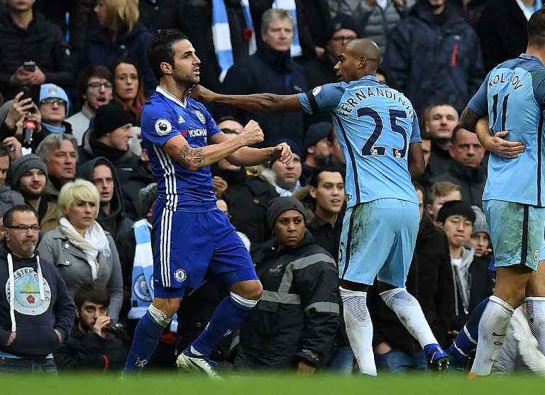Manchester City's Brazilian midfielder Fernandinho (R) fights with Chelsea's Spanish midfielder Cesc Fabregas following Manchester City's Argentinian striker Sergio Aguero's challenge on Chelsea's Brazilian defender David Luiz, during the English Premier League football match between Manchester City and Chelsea at the Etihad Stadium in Manchester, north west England, on December 3, 2016. / AFP PHOTO / Paul ELLIS / RESTRICTED TO EDITORIAL USE. No use with unauthorized audio, video, data, fixture lists, club/league logos or 'live' services. Online in-match use limited to 75 images, no video emulation. No use in betting, games or single club/league/player publications. /