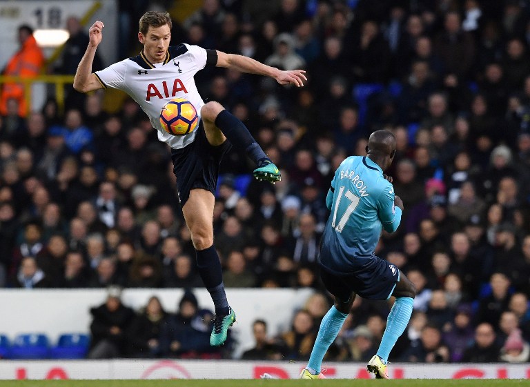 Tottenham Hotspur's Belgian defender Jan Vertonghen (L) Swansea City's Gambian-Swedish striker Modou Barrow during the English Premier League football match between Tottenham Hotspur and Swansea City at White Hart Lane in London, on December 3, 2016. Tottenham won the match 5-0. / AFP PHOTO / Ben STANSALL / RESTRICTED TO EDITORIAL USE. No use with unauthorized audio, video, data, fixture lists, club/league logos or 'live' services. Online in-match use limited to 75 images, no video emulation. No use in betting, games or single club/league/player publications. /