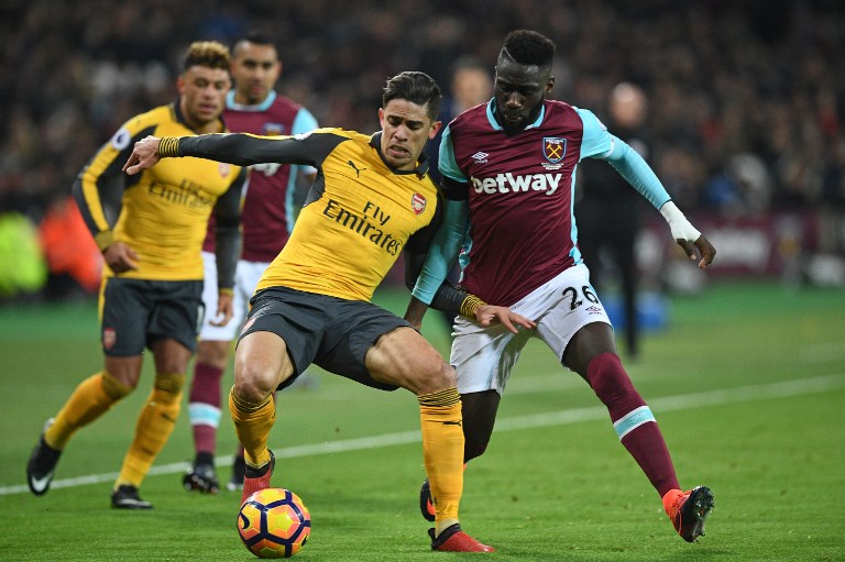 West Ham United's French defender Arthur Masuaku (R) vies with Arsenal's Brazilian defender Gabriel during the English Premier League football match between West Ham United and Arsenal at The London Stadium, in east London on December 3, 2016. / AFP PHOTO / Justin TALLIS / RESTRICTED TO EDITORIAL USE. No use with unauthorized audio, video, data, fixture lists, club/league logos or 'live' services. Online in-match use limited to 75 images, no video emulation. No use in betting, games or single club/league/player publications. /
