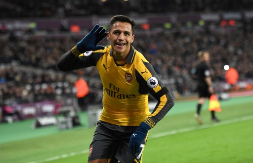 Arsenal's Chilean striker Alexis Sanchez celebrates after scoring their second goal during the English Premier League football match between West Ham United and Arsenal at The London Stadium, in east London on December 3, 2016. / AFP PHOTO / Justin TALLIS / RESTRICTED TO EDITORIAL USE. No use with unauthorized audio, video, data, fixture lists, club/league logos or 'live' services. Online in-match use limited to 75 images, no video emulation. No use in betting, games or single club/league/player publications. /