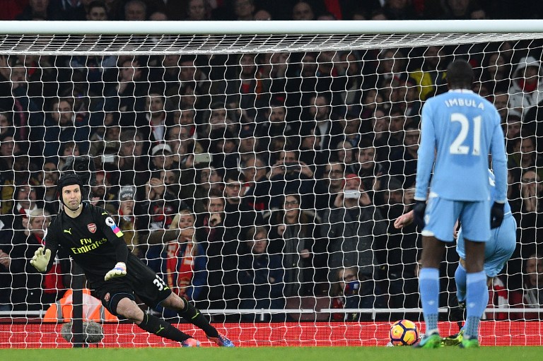 Stoke City's Scottish midfielder Charlie Adam (R) scores from the penalty spot past Arsenal's Czech goalkeeper Petr Cech during the English Premier League football match between Arsenal and Stoke City at the Emirates Stadium in London on December 10, 2016. / AFP PHOTO / Glyn KIRK / RESTRICTED TO EDITORIAL USE. No use with unauthorized audio, video, data, fixture lists, club/league logos or 'live' services. Online in-match use limited to 75 images, no video emulation. No use in betting, games or single club/league/player publications. /