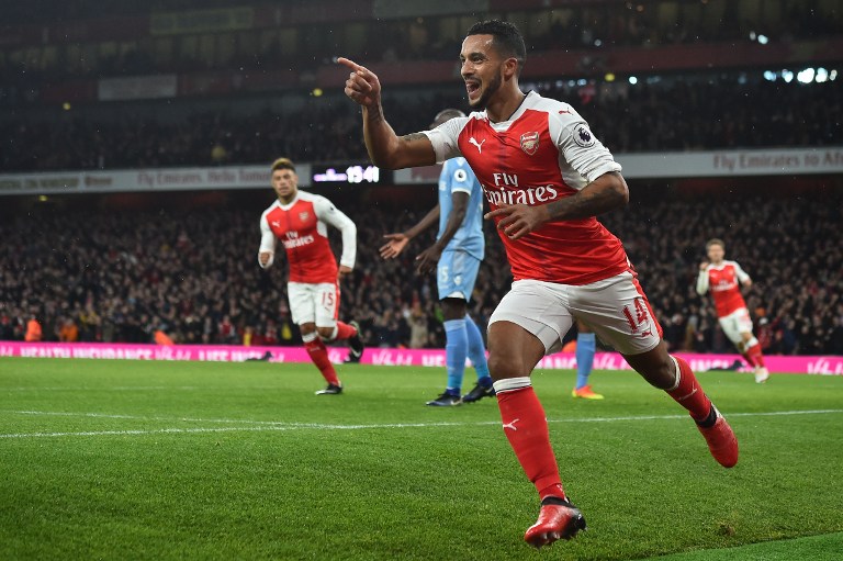 Arsenal's English midfielder Theo Walcott (R) celebrates after scoring during the English Premier League football match between Arsenal and Stoke City at the Emirates Stadium in London on December 10, 2016. / AFP PHOTO / Glyn KIRK / RESTRICTED TO EDITORIAL USE. No use with unauthorized audio, video, data, fixture lists, club/league logos or 'live' services. Online in-match use limited to 75 images, no video emulation. No use in betting, games or single club/league/player publications. /